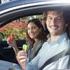 man and woman in vehicle with resqmes in hand